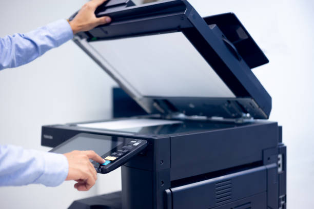 istock Bussiness man Hand press button on panel of printer, printer scanner laser in office copy machine supplies start concept. 1310702236