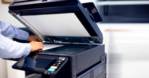 istock Bussiness man Hand press button on panel of printer, printer scanner laser in office copy machine supplies start concept. 1310702249
