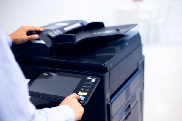 istock Bussiness man Hand press button on panel of printer, printer scanner laser in office copy machine supplies start concept. 1310702250