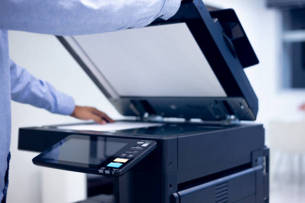 istock Bussiness man Hand press button on panel of printer, printer scanner laser in office copy machine supplies start concept. 1310702271