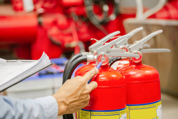 istock Engineer inspection Fire extinguisher and fire hose,Ready to use in the event of a fire.Safety first concept. 1310702307