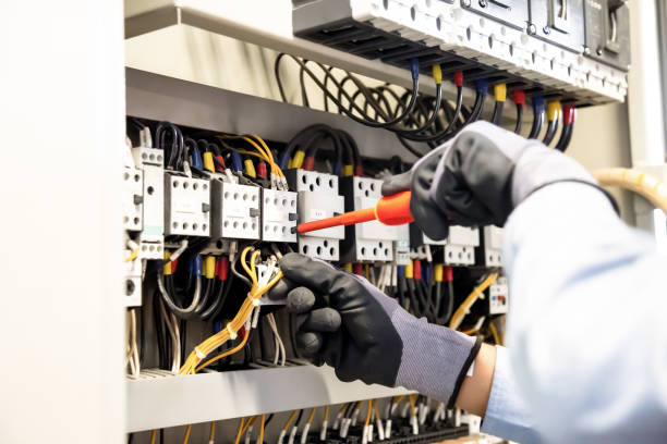 istock Electricians work to connect electric wires in the system, switchboard, electrical system in Control cabinet. 1310702334
