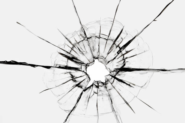 Cracks in the window from a shot from a weapon. Damaged window glass.