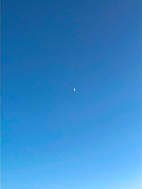 istock White rising moon in a beautiful blue sky 1310707051