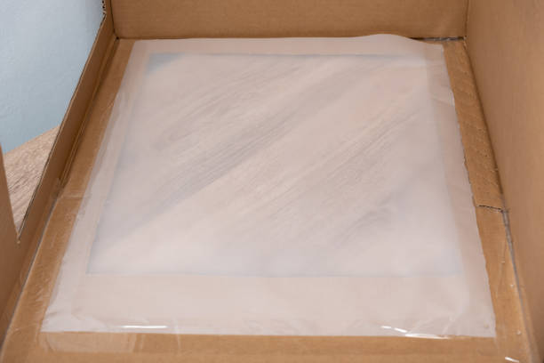 Tissue paper sheet pasted to carton box with shipping tape stock photo