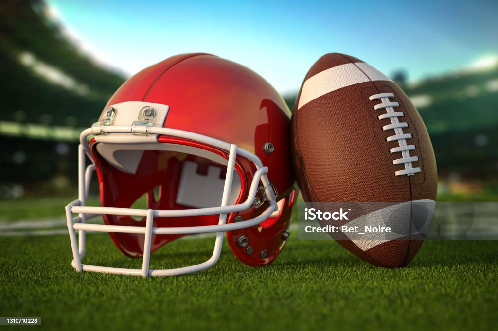 American football ball and helmet on the grass of football arena or stadium. American football ball and helmet on the grass of football arena or stadium. 3d illustration American Football - Sport Stock Photo