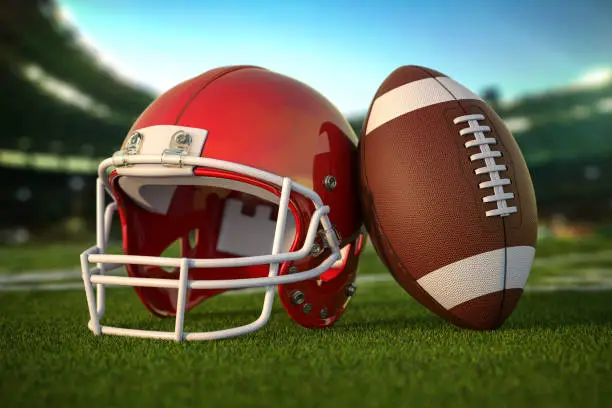 American football ball and helmet on the grass of football arena or stadium. 3d illustration