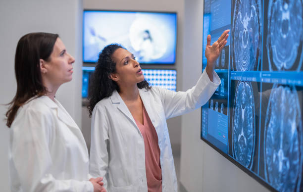 doctors consult over an mri scan - research medical student doctor clinic imagens e fotografias de stock