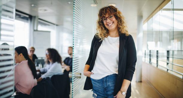 istock Smiling business executive outside office boardroom 1310715455