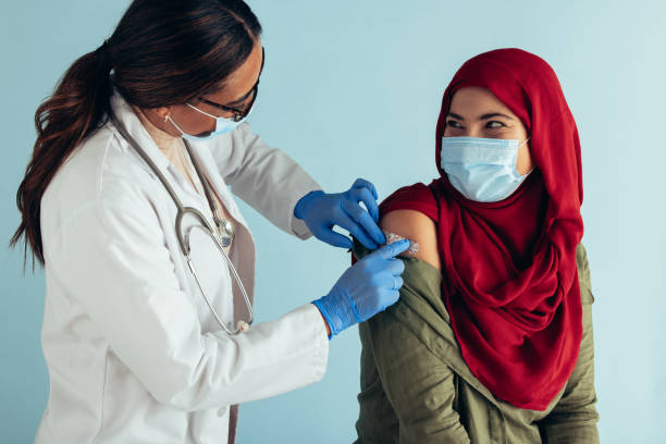istock Muslim woman getting covid vaccine 1310716455