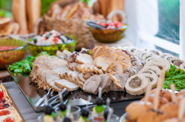 istock Wedding Table With Food. Snacks and Appetizer on the Table. Fish and Raw Meat with Vegetables. Sliced Bacon Meat. 1310717634