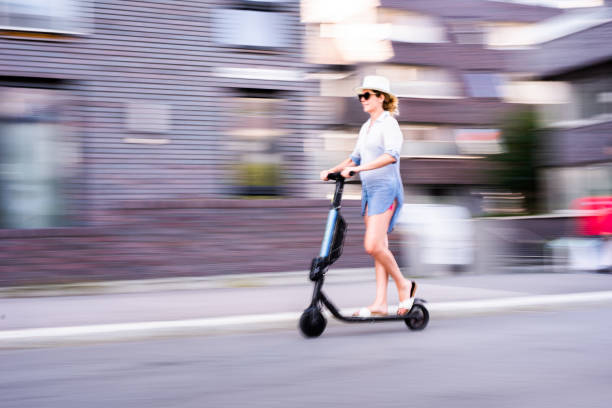 istock Blurred motion of young woman riding an e-scooter 1310723499