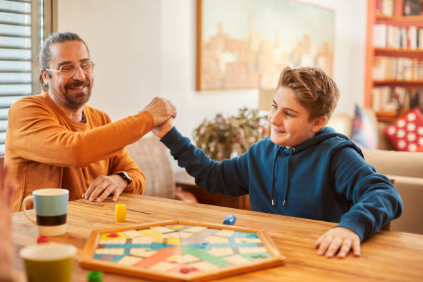 istock Father and son happy after winning a board game match. 1310724481