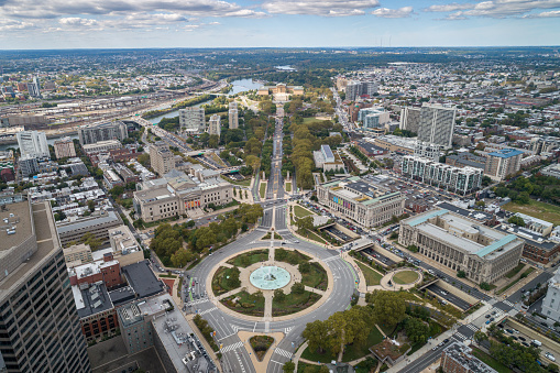 Logan Square and Philadelphia Skyline, Downtown. Pennsylvania, USA. Traffic circle center features a large fountain with whimsical statuary, garden areas with benches.