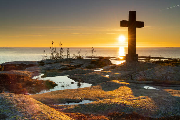 istock Catholic cross towering over the fjord 1310725852