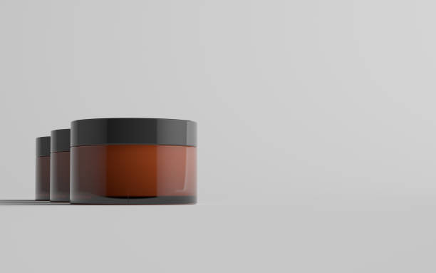 istock Amber Glass Cosmetic Jar Mockup - Three Jars 1310725984
