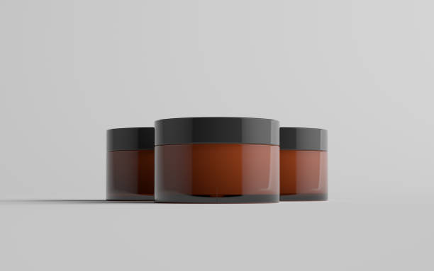 istock Amber Glass Cosmetic Jar Mockup - Three Jars 1310725992