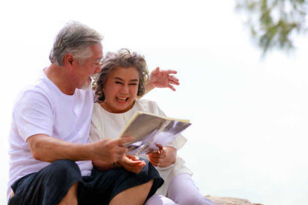 istock Happy elderly retirement senior couple have fun while reading a book together. 1310726979