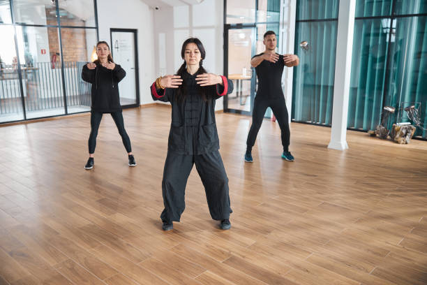 istock Two women and sportive man using tai chi form 1310727286