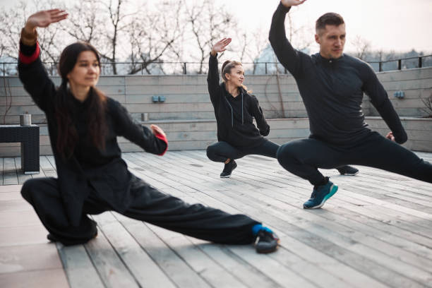 istock Martial arts athletes doing a stretching activity on roof 1310727335