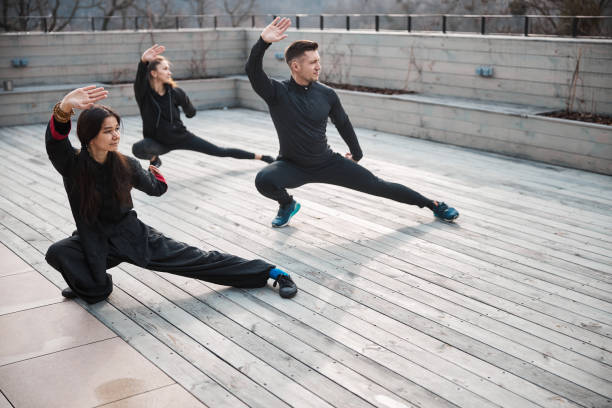 istock Tai chi training of a group outdoors on roof 1310727341