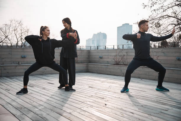 istock Wushu instructor changing finger position of woman 1310727345