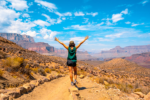 A young woman with open arms on the South Kaibab Trailhead trek. Grand Canyon\