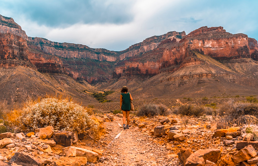 A young woman walking along the Bright Angel Trailhead at the Tonto West turnoff, in the Grand Canyon. Arizona