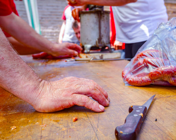 Butcher holds his hand on wooden table, board