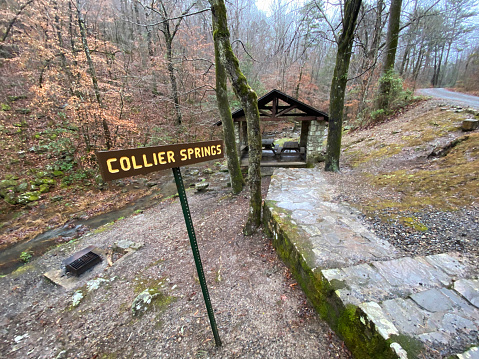 Sign by pavilion and stone staircase for Collier Springs