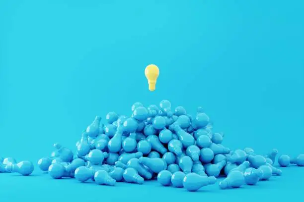 Photo of Yellow Light bulb Floating on blue color light bulb Overlap on blue background. Minimal idea concept. 3D Render.