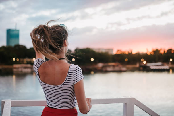 istock Young woman standing by the river 1310738386