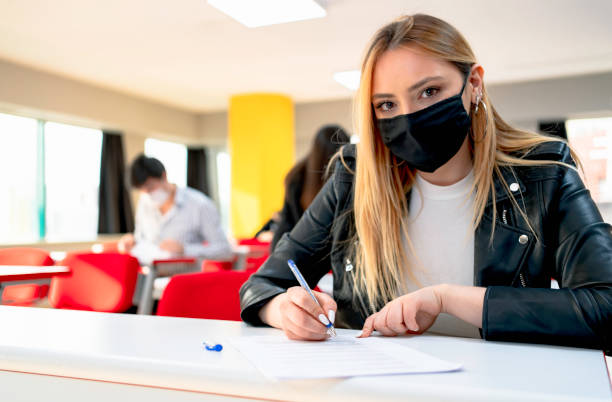 istock university Students In Classroom Wearing Protective Face Mask 1310739057