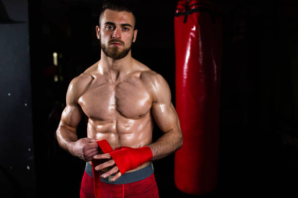 istock A handsome muscular boxer posing for a photo while wrapping his hand 1310740524