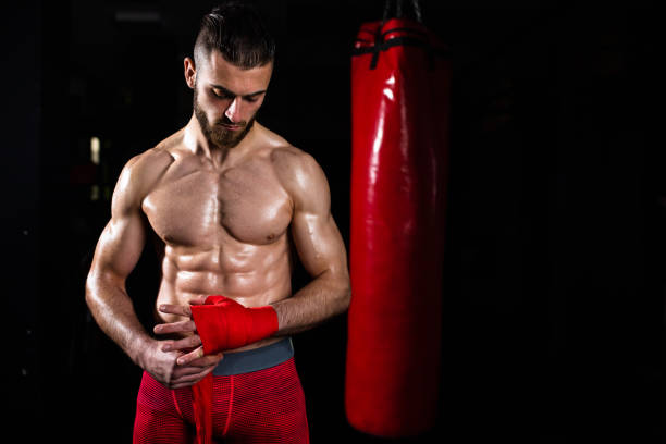 istock A muscular young man wrapping his hand for boxing 1310740526