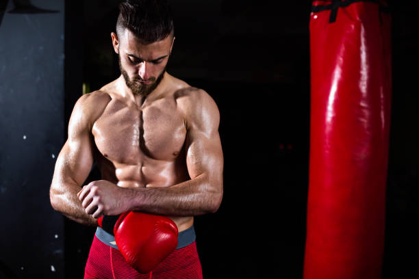 istock A muscular boxer putting on his gloves 1310740559