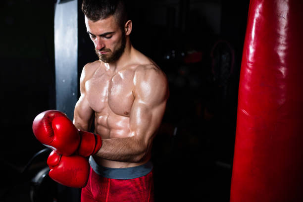 istock A boxer tightening his boxing gloves 1310740560