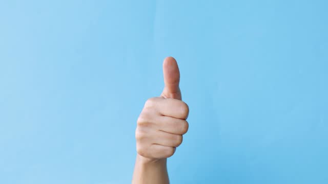 Thumbs up on blue background - well done