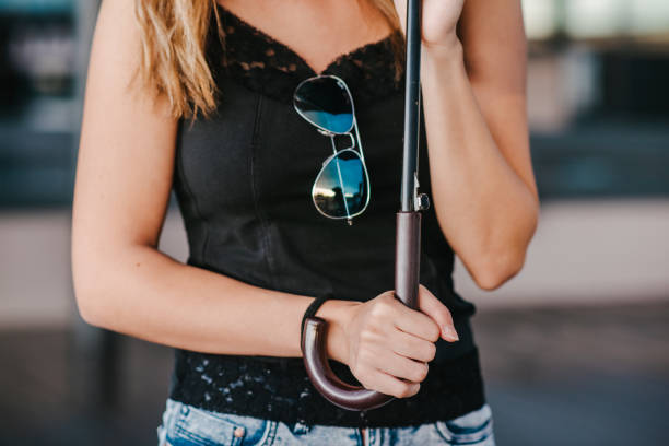 istock Young woman holding an umbrella 1310742597