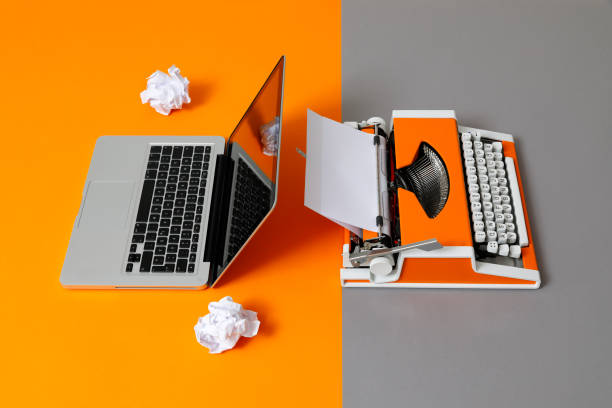 istock Digital and analog – Laptop and 70s Typewriter 1310742631