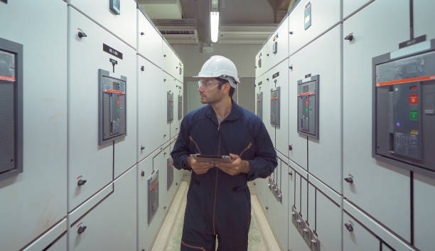 istock An engineer man or worker, people working in electrical room. Power energy motor machinery cabinets in control or server room, operator station network and circuit center in industry factory system. 1310743459
