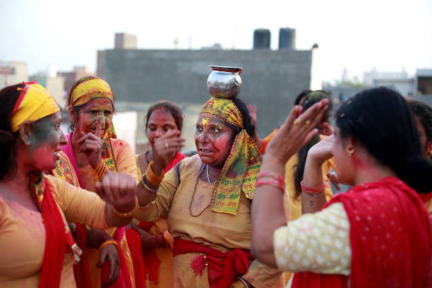 Mature female friends group dancing and enjoying Holi festival Group of mature women of Indian ethnicity celebrating Holi festival during summer season. It is celebrated predominantly in India and Nepal. Holi is popularly known as the Indian "festival of spring", the "festival of colors", or the "festival of love." lota stock pictures, royalty-free photos & images