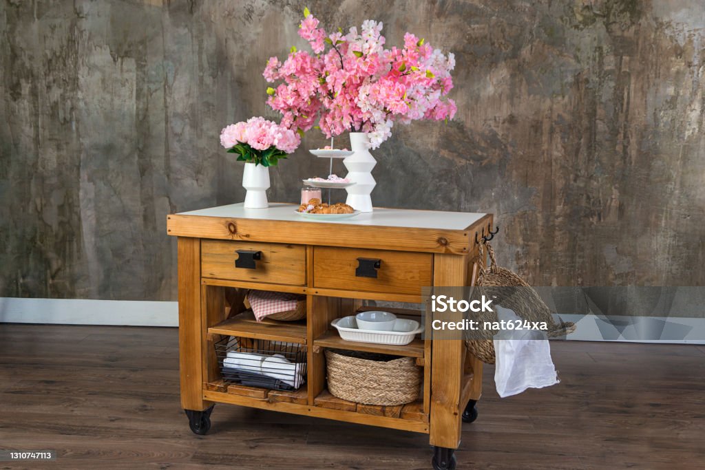View on Flowers, candle and sweets on a Old Antique Wooden Drawer with a space for text Arrangement Stock Photo