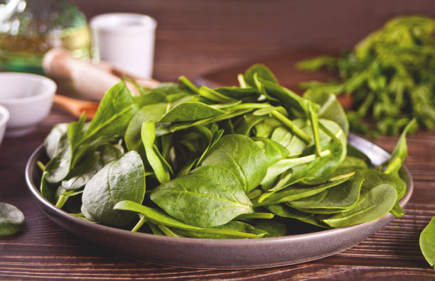 istock spinach on the plate on the dark wooden background 1310749418
