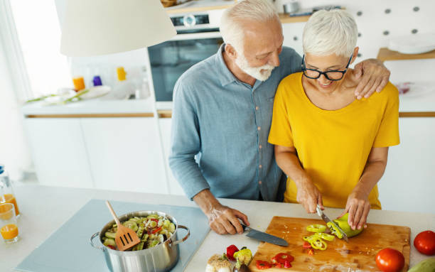 istock Mature couple cooking lunch together. 1310749432
