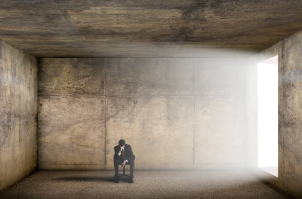 istock Stressed Man Sitting Alone In Stark Concrete Room 1310751685