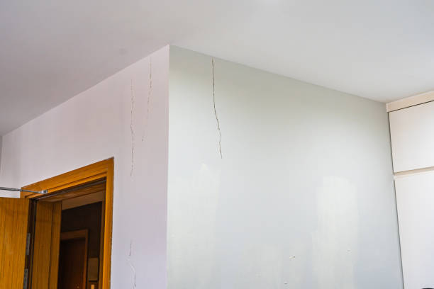 istock White painted house with cracked wall near ceiling 1310751944