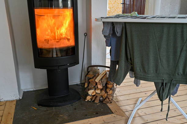 istock fire in stove drying clothes on drying rack 1310754404