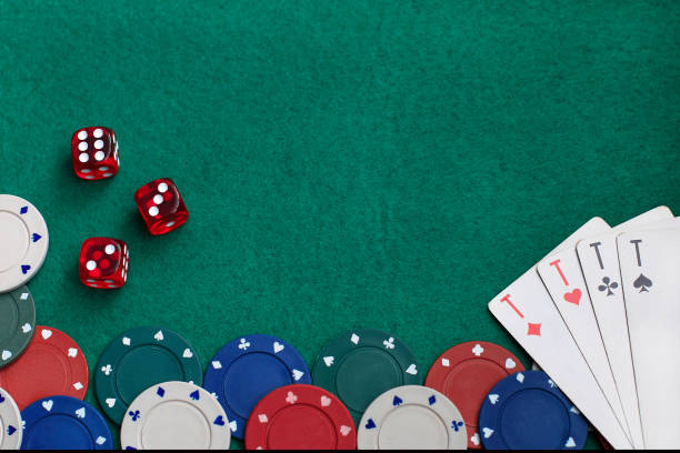 istock Playing cards,dices and poker chips from above on green poker table 1310754515