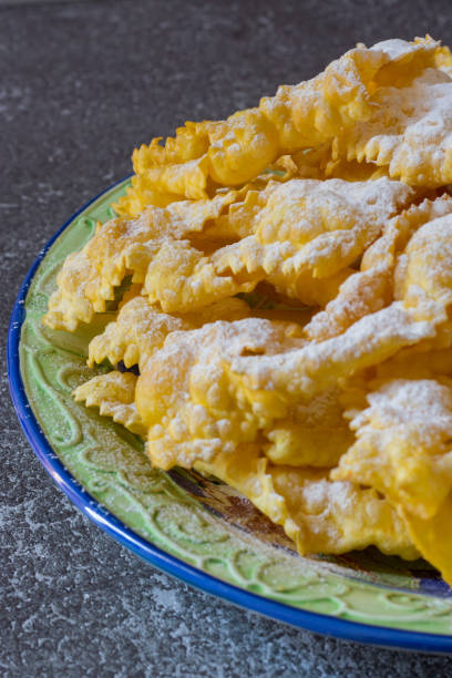istock Carrot-flavored fried sheets. Dough of flour and boiled carrots, pulled with a pasta machine and fried in oil sprinkled with icing sugar 1310754897